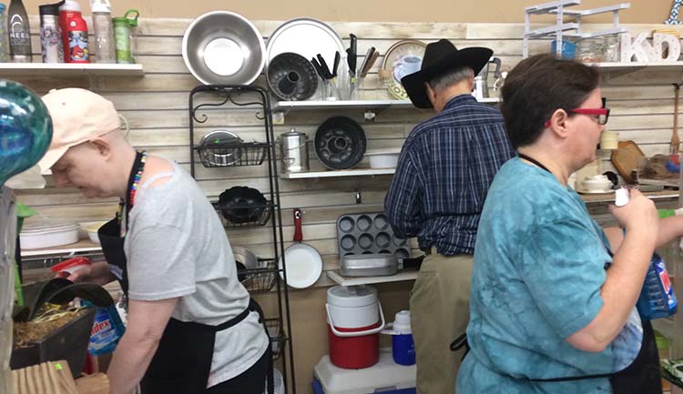 3 people work in a store selling mostly kitchen tools