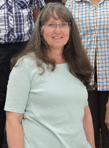 A headshot of a smiling person