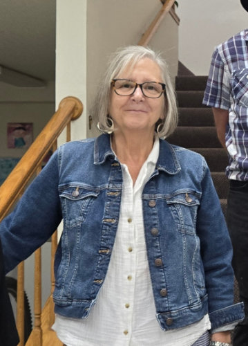 A headshot of a smiling person